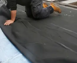 skilled flooring installer laying moisture barrier, gold goast byron bay brisbane Evolved Floors